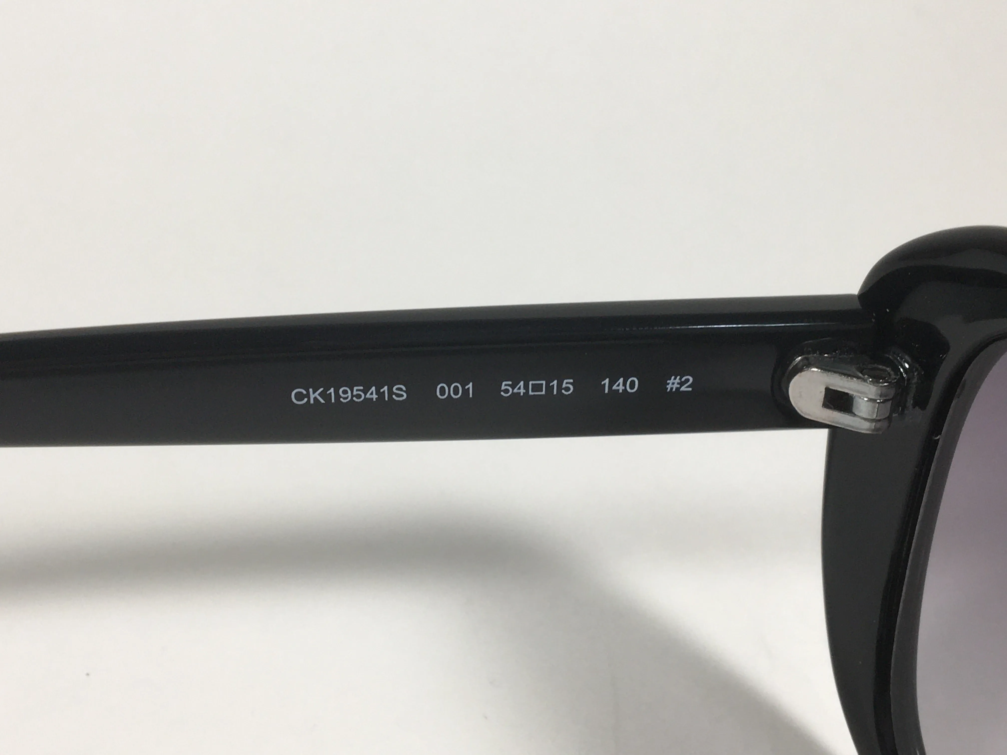 Calvin Klein Oval Sunglasses CK19541S 001 Black Gloss Frame Gray Smoke Gradient Lens