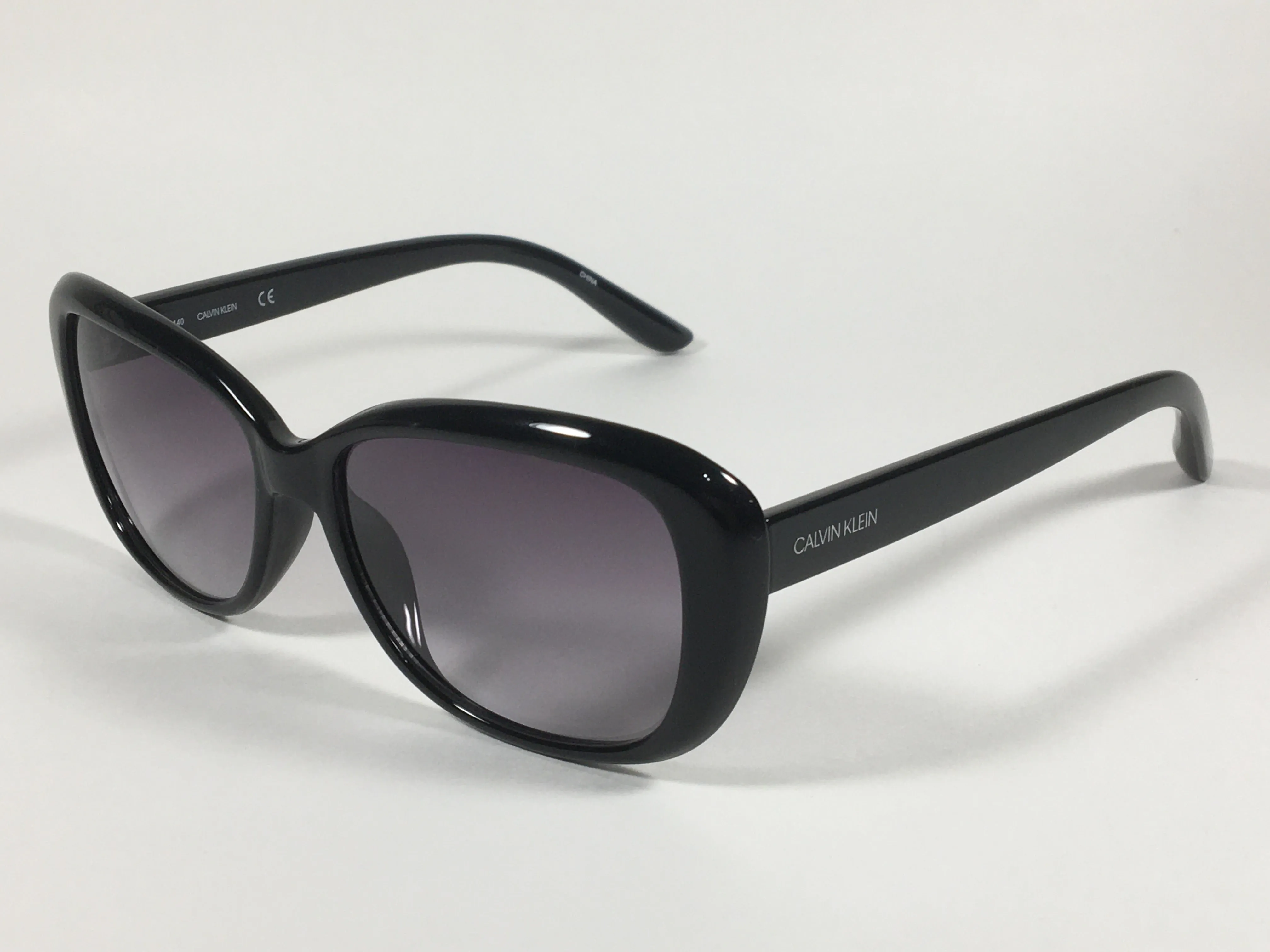 Calvin Klein Oval Sunglasses CK19541S 001 Black Gloss Frame Gray Smoke Gradient Lens